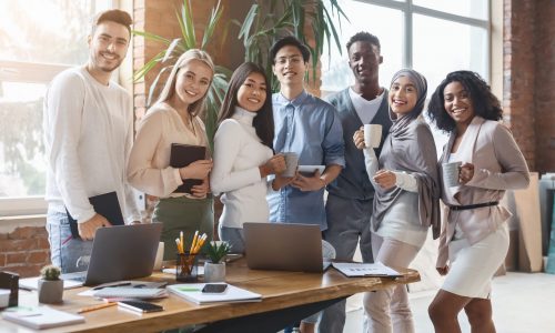 Portrait,Of,Young,Cheerful,International,Business,Team,Posing,Together,In